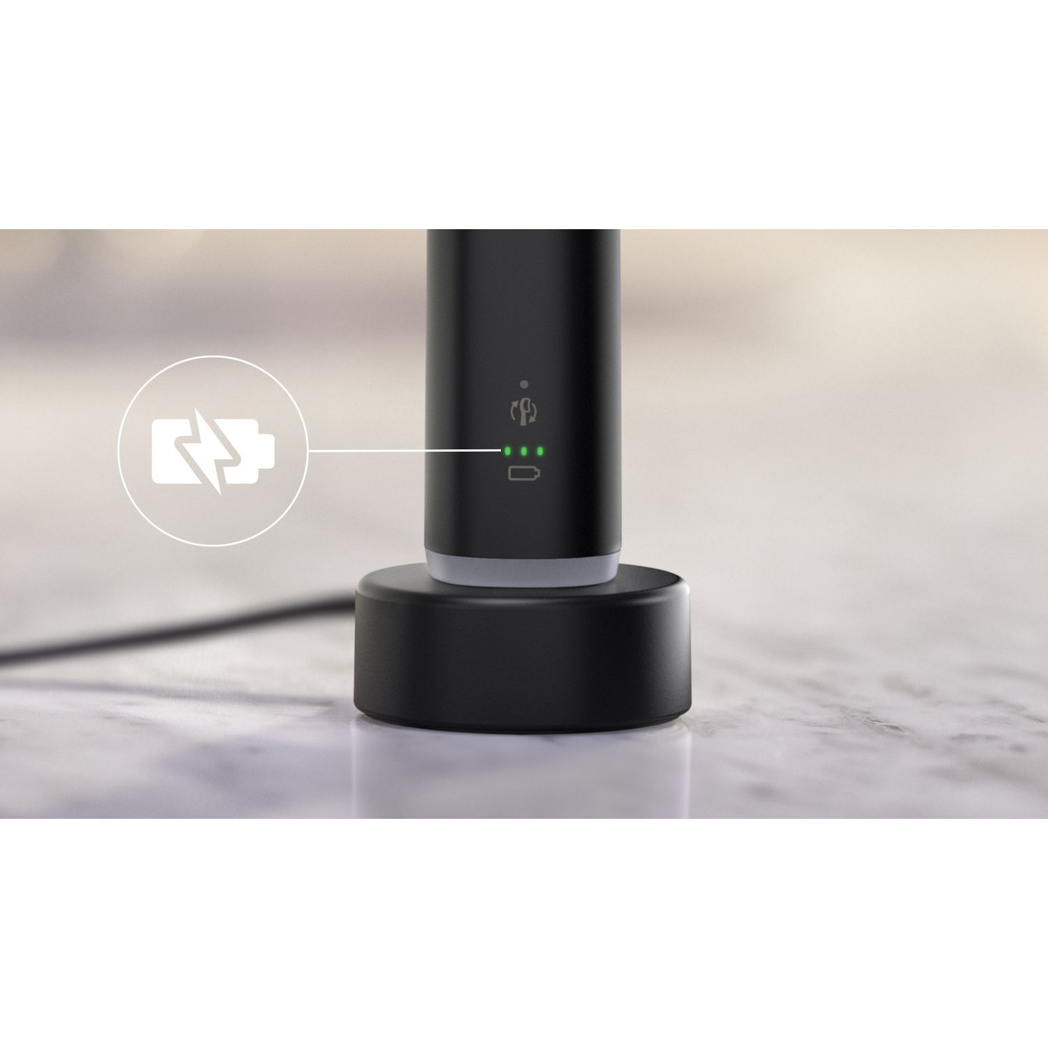 A black charging base with a charging symbol and green LED lights is on a surface.