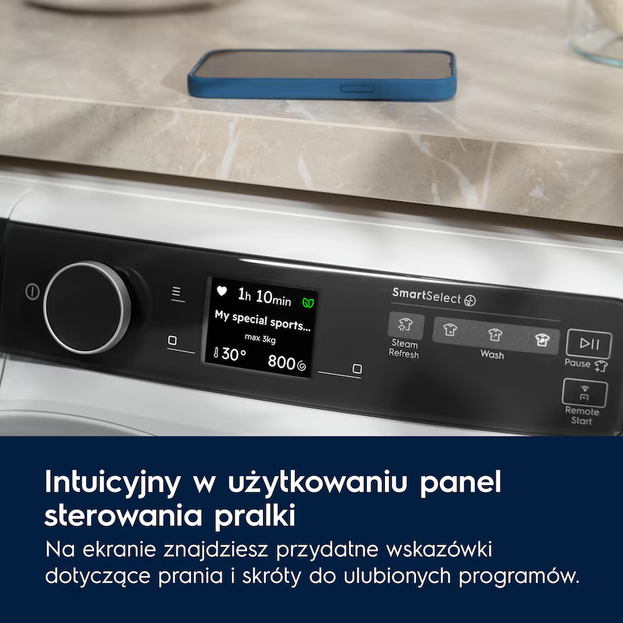 Panel sterowania pralki z telefonem na wierzchu, z tekstem po polsku poniżej.