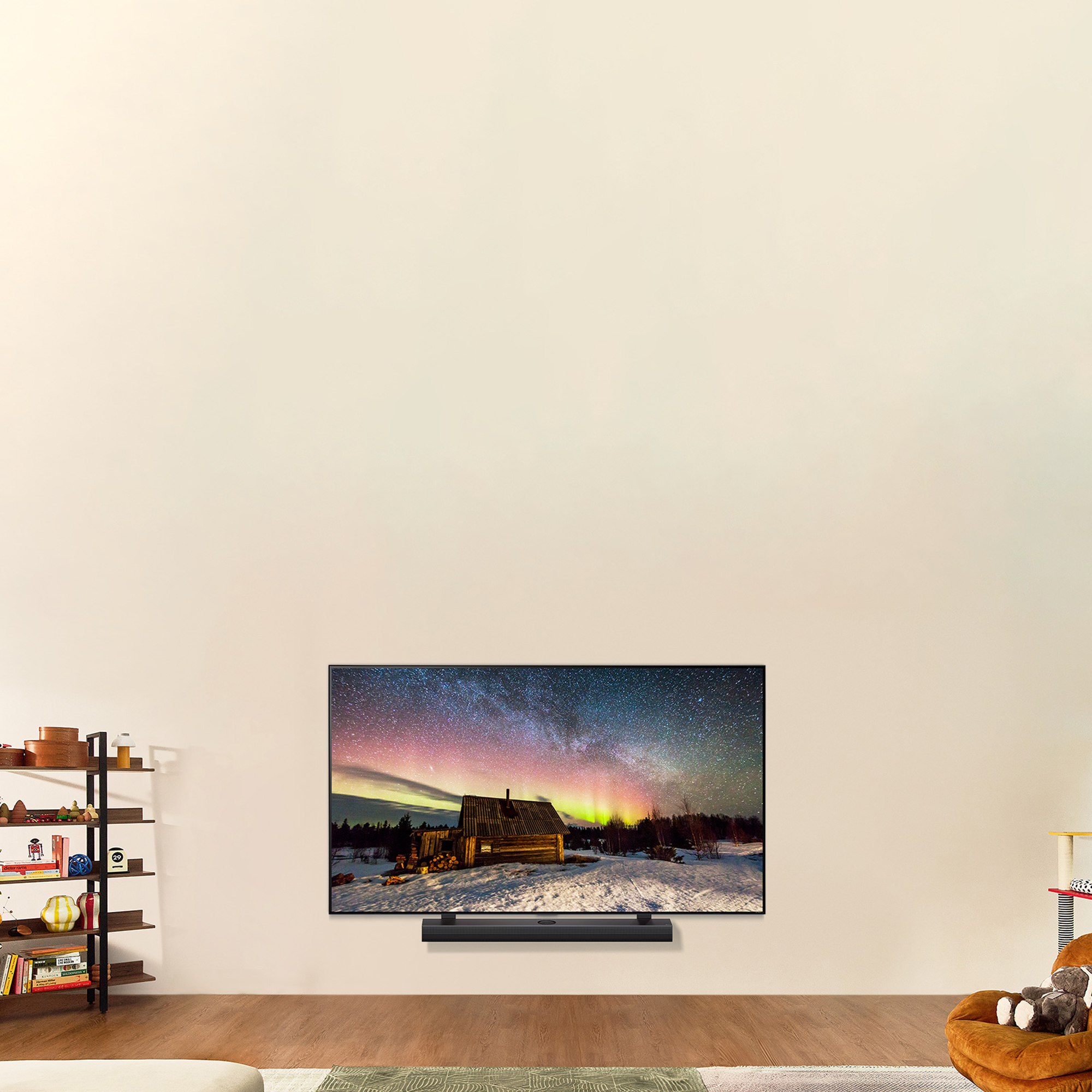 Un televisor que muestra una escena nocturna con la aurora boreal. El televisor está en la pared, con una barra de sonido.