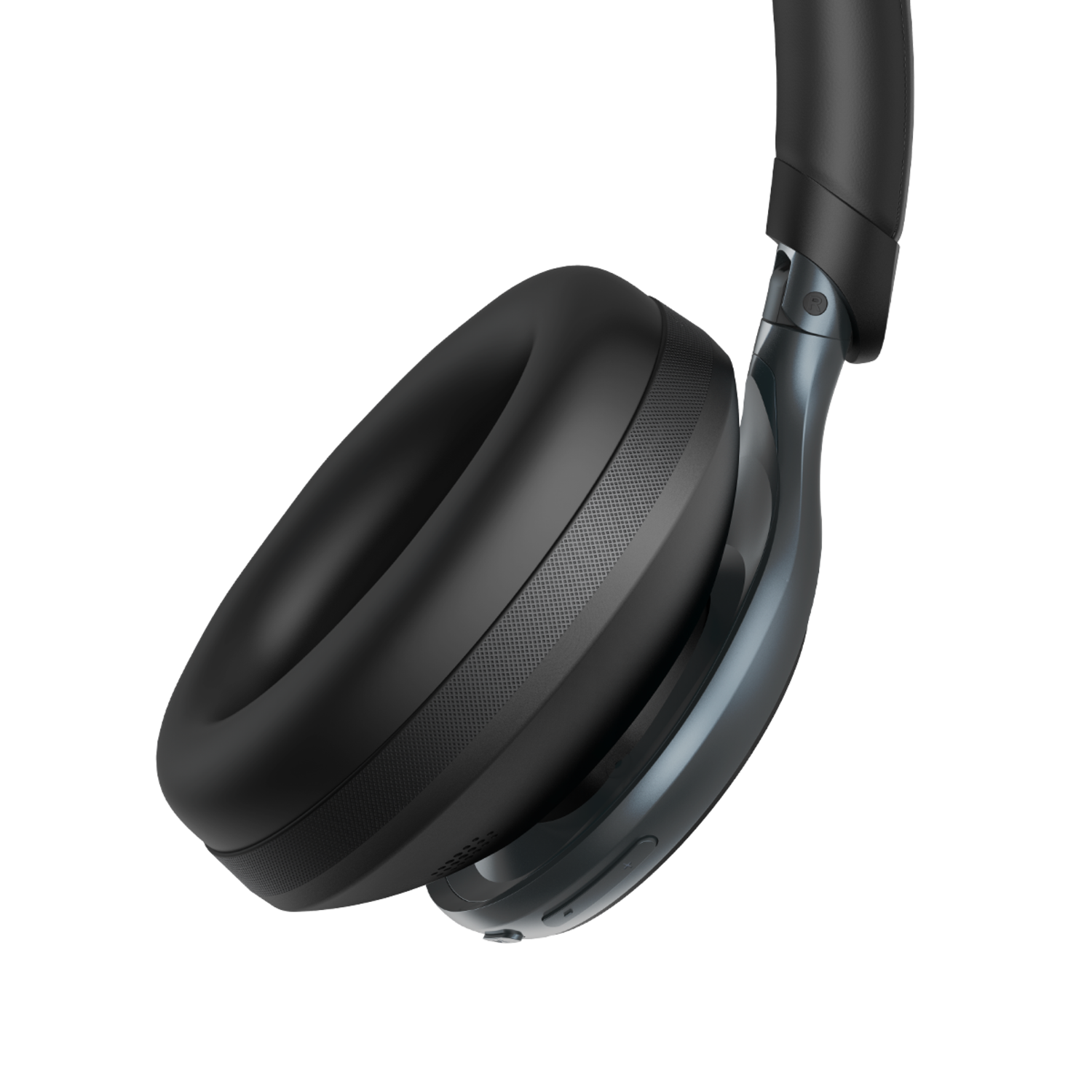 A close-up of a black over-ear headphone, angled, against a black background. The ear cup is visible.