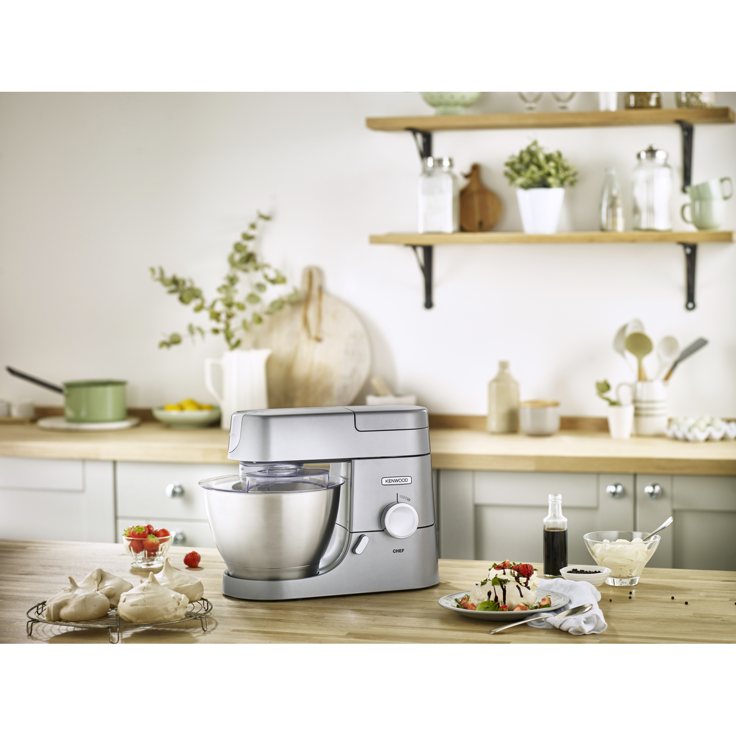 Kitchen scene with a Kenwood Chef, ingredients and a dessert on a table.