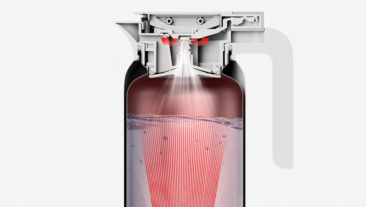 Przekrój czajnika z czerwonym strumieniem światła wskazującym element grzejny.