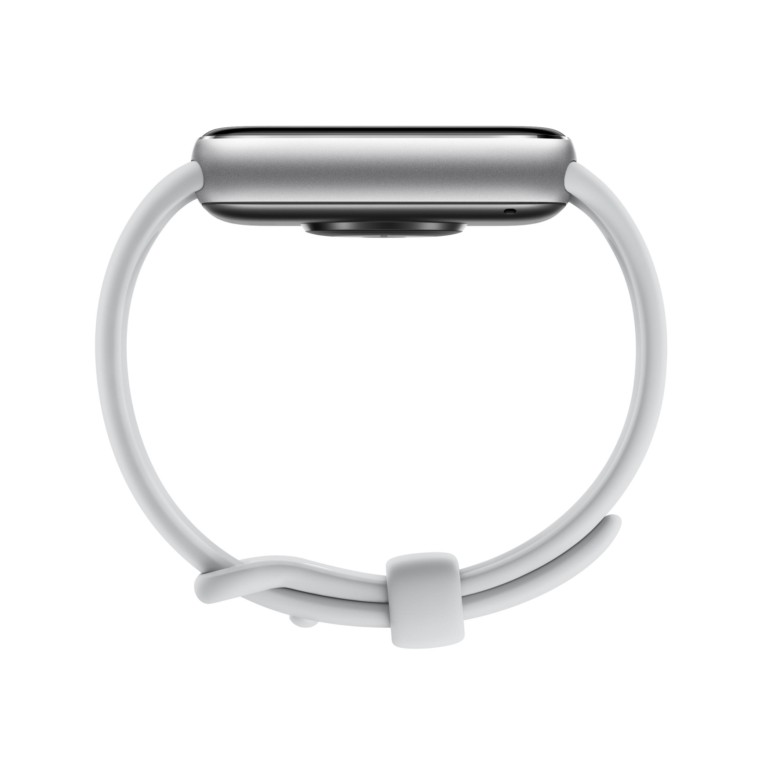 Eine silberne Smartwatch mit weißem Armband, von der Seite betrachtet.