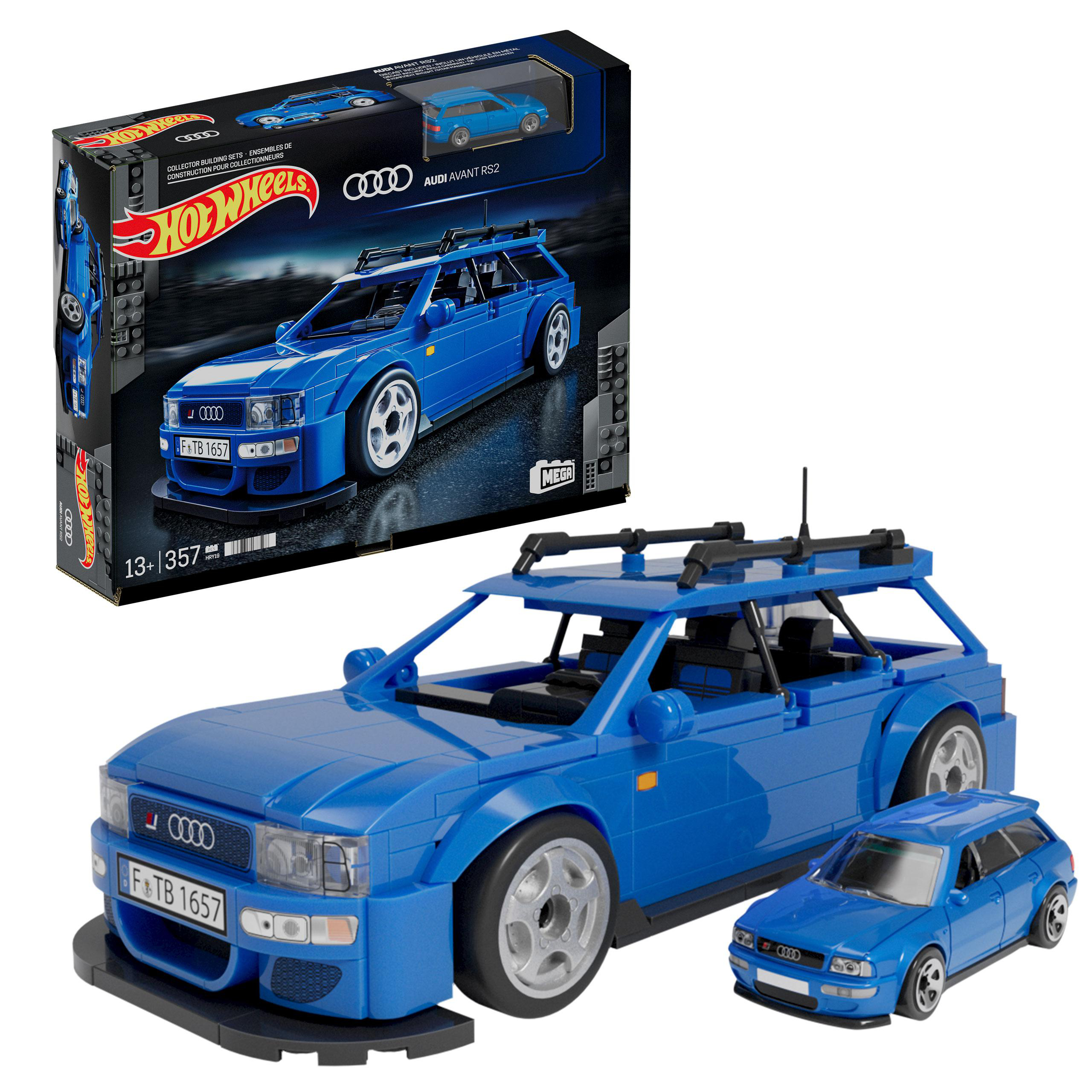 Ein blaues Hot Wheels Audi Avant RS2 Automodell und eine Box, mit einem kleinen Modellauto daneben.