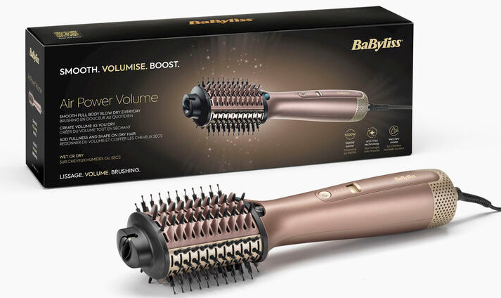 Złoto-czarna szczotka do stylizacji włosów, obok opakowania, na białej powierzchni.