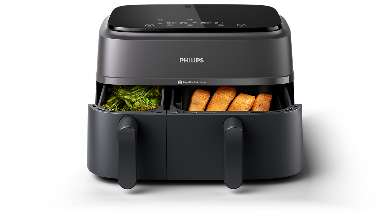 Eine schwarze Philips Heißluftfritteuse mit zwei Fächern und Essen darin.