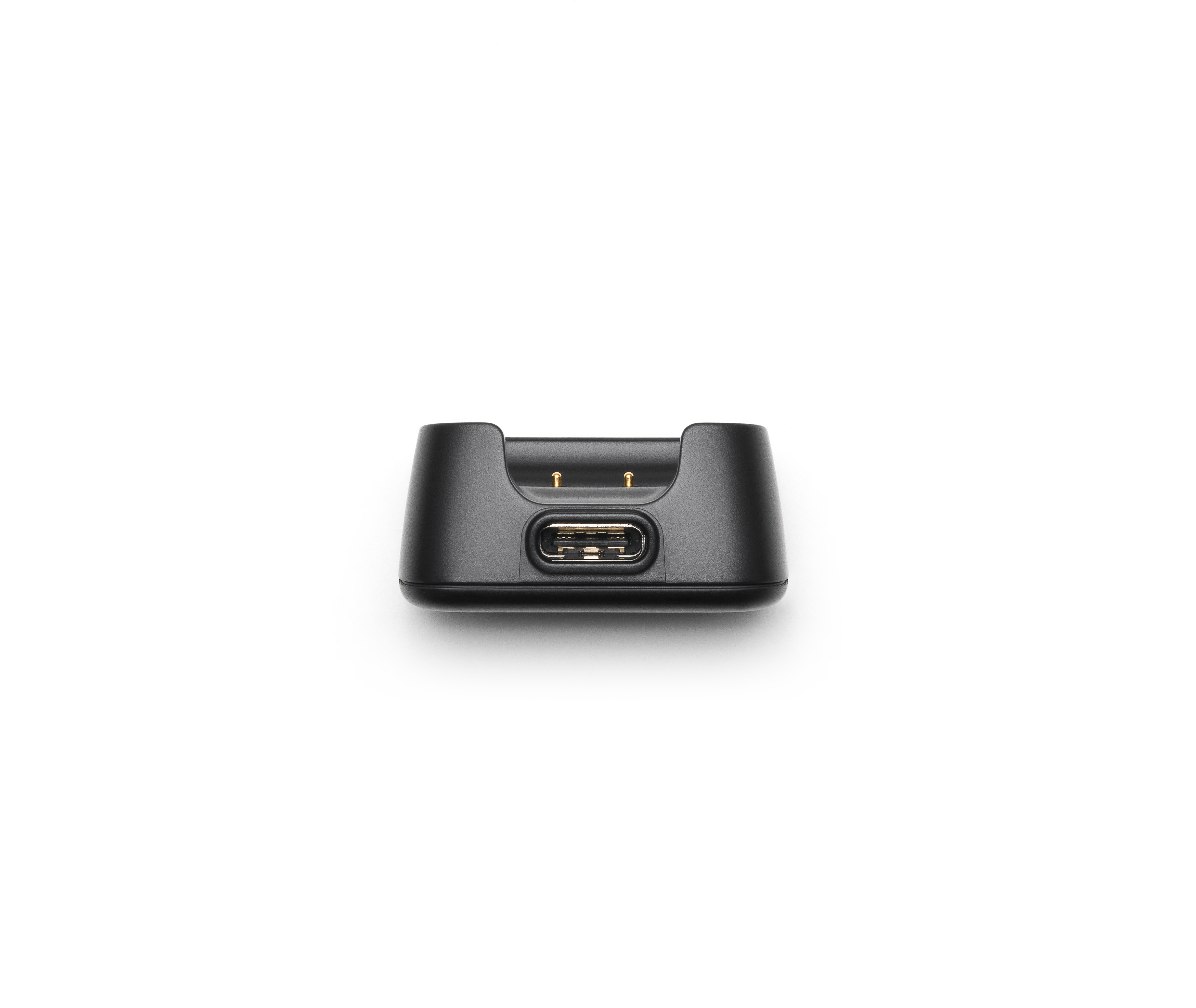 Eine schwarze Ladestation mit USB-Anschluss. Die Ansicht ist von unten.