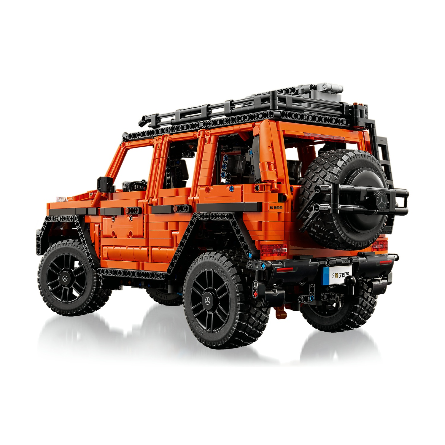 Lego Technic G 500 arancione. Ruote nere, portapacchi e ruota di scorta. Sfondo bianco. Vista laterale.