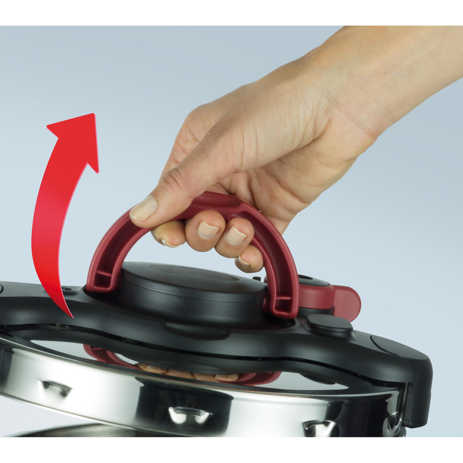 A red handle is being lifted on a black appliance.