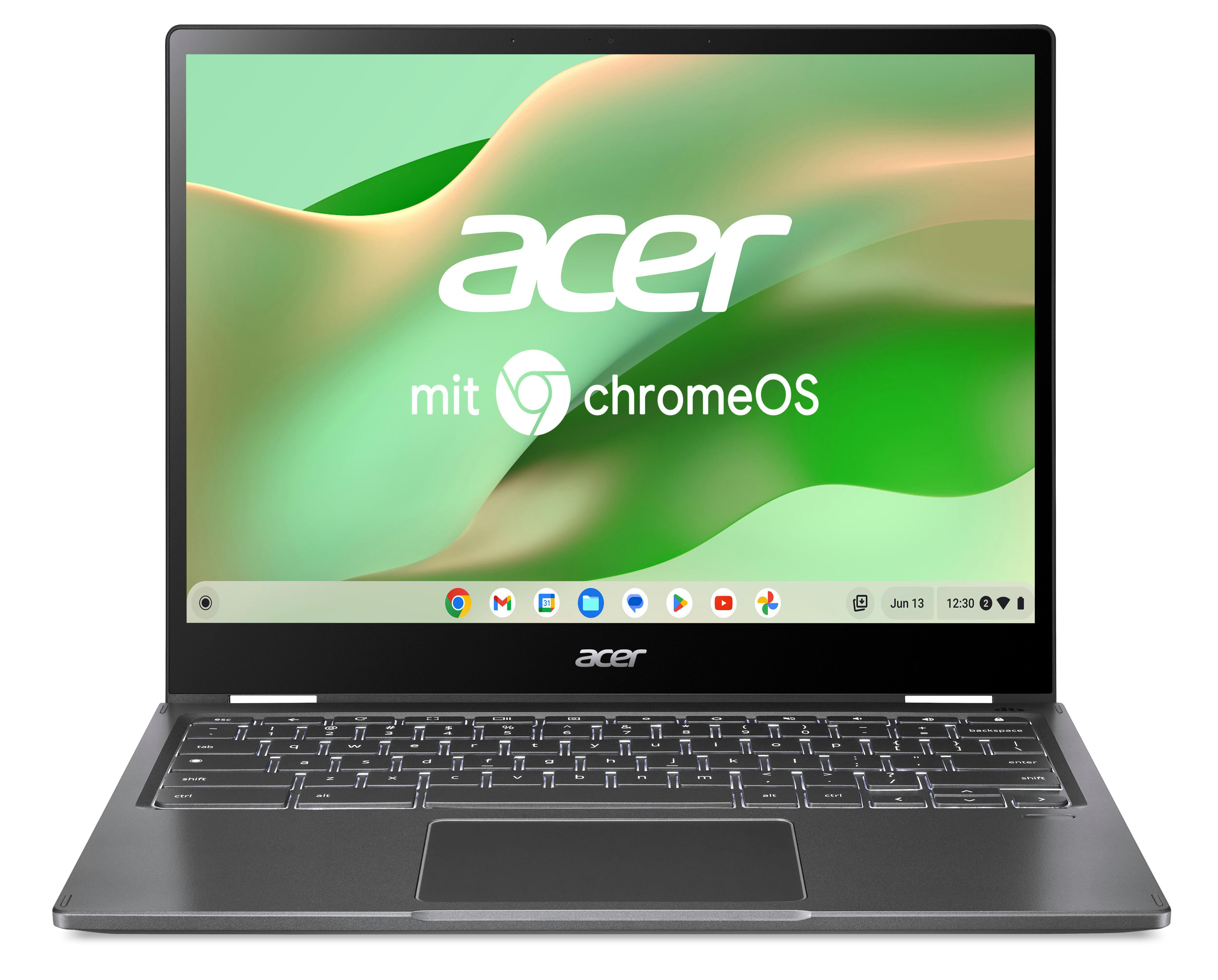 Ein graues Acer Chromebook-Laptop, das auf einem Tisch geöffnet ist. Es hat einen Bildschirm, der das Chrome OS-Logo und Apps zeigt.