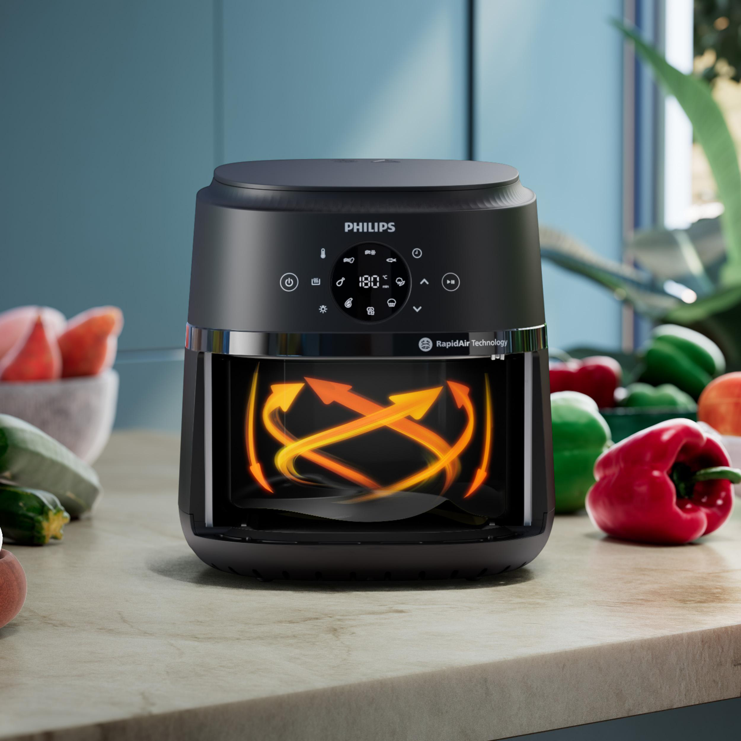 Schwarzer Philips Heißluftfritteuse mit digitalem Display, umgeben von frischem Gemüse.