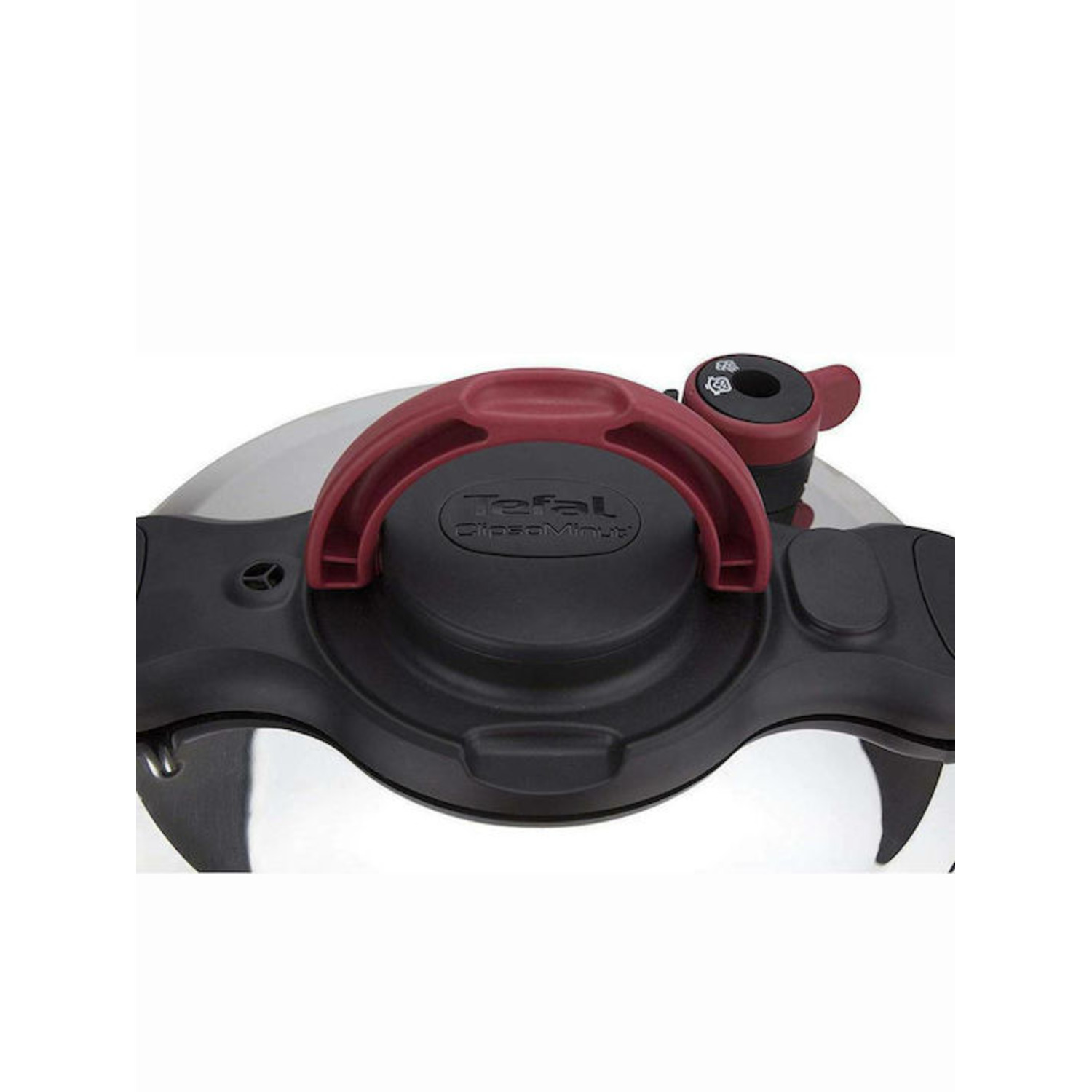 Close-up of a pressure cooker lid with a red handle and black accents.