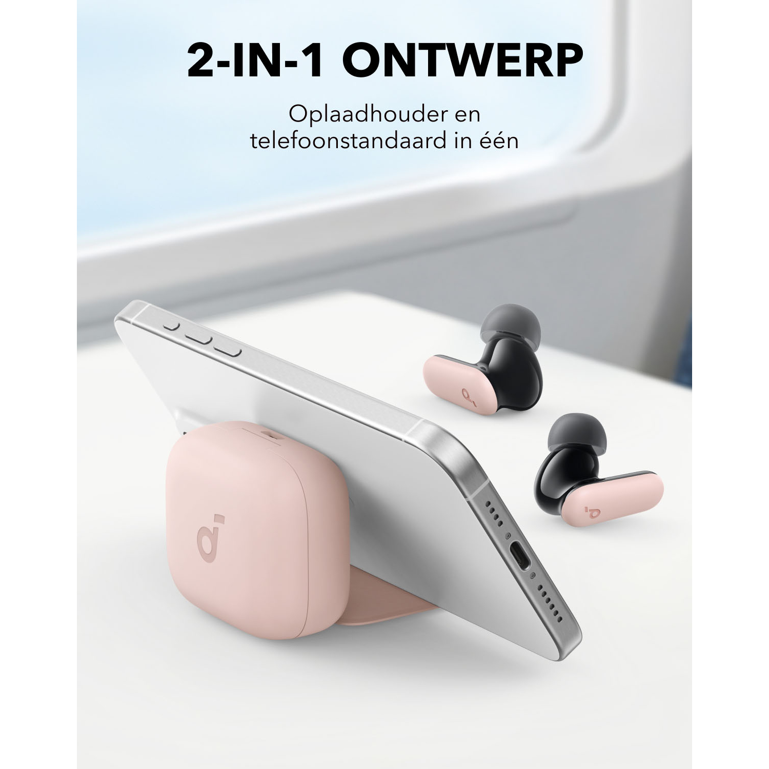 Een roze oplaadstandaard met een telefoon en oordopjes op een tafel, met tekst erboven.