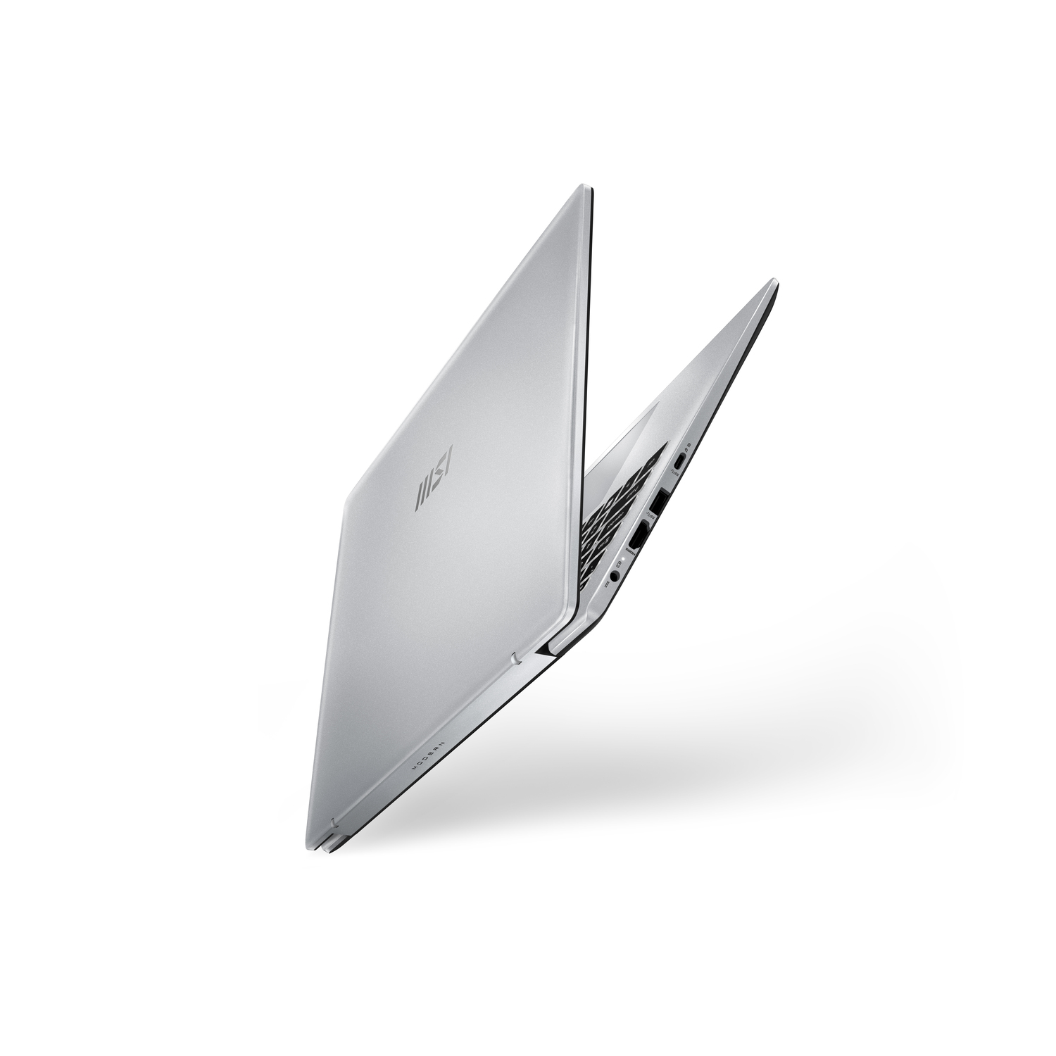 A silver laptop is seen from a side angle against a white backdrop.