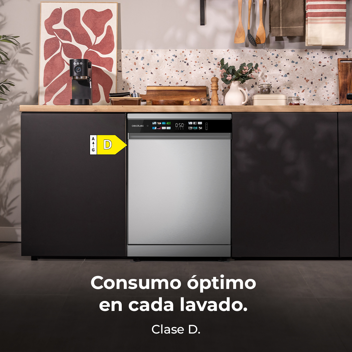 Se muestra un lavavajillas plateado y negro en una cocina. Un letrero indica una clase de energía D.
