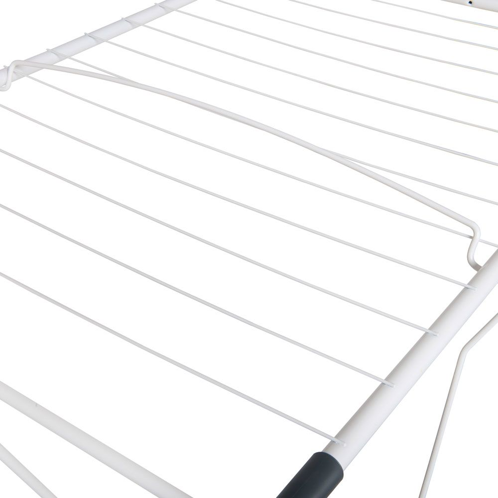 Zbliżenie białej suszarki do ubrań z równoległymi liniami. Suszarka jest na białym tle.