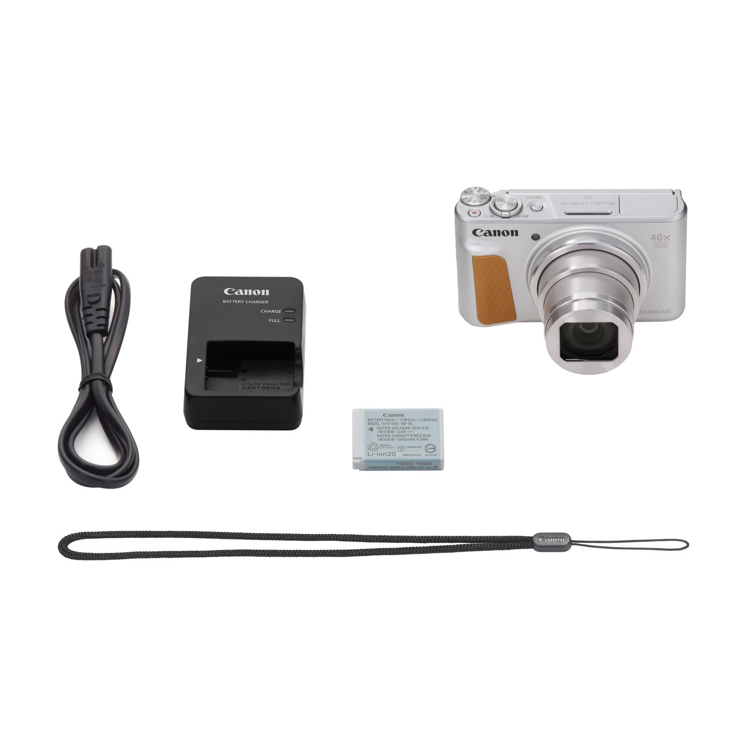 Una fotocamera con accessori tra cui caricabatterie, batteria e cinturino.