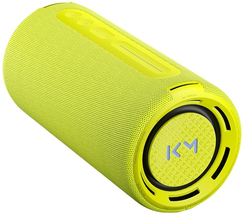 Cylindryczny żółty głośnik. Przyciski i logo znajdują się na górze.