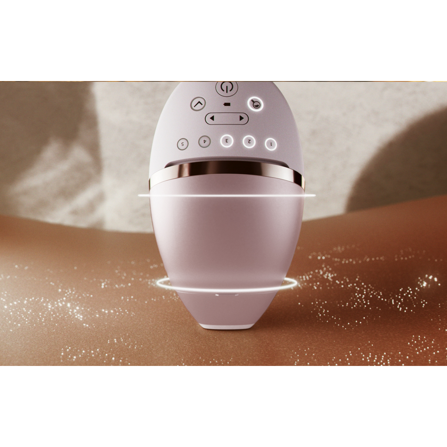 Close-up of a hair removal device. Device is white and pink, skin is brown. Light beams around.
