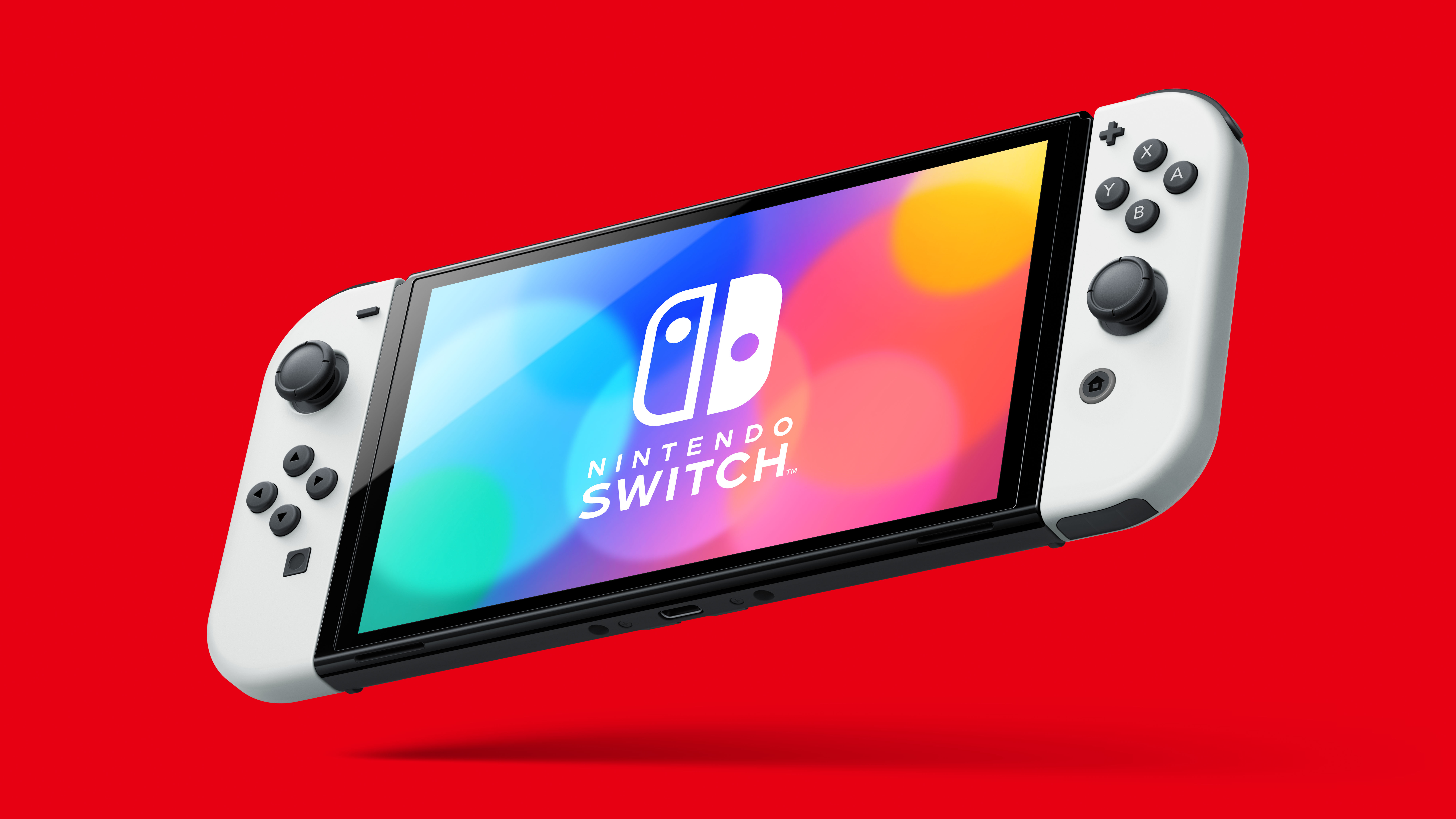 Une console Nintendo Switch blanche et noire sur fond rouge.