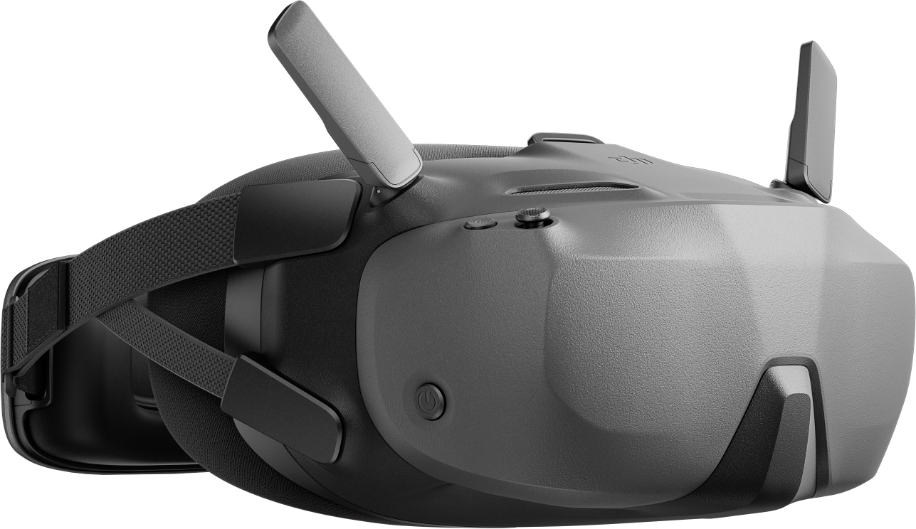 Graues VR-Headset mit zwei Antennen, schwarzen Riemen und Knöpfen, vor schwarzem Hintergrund.