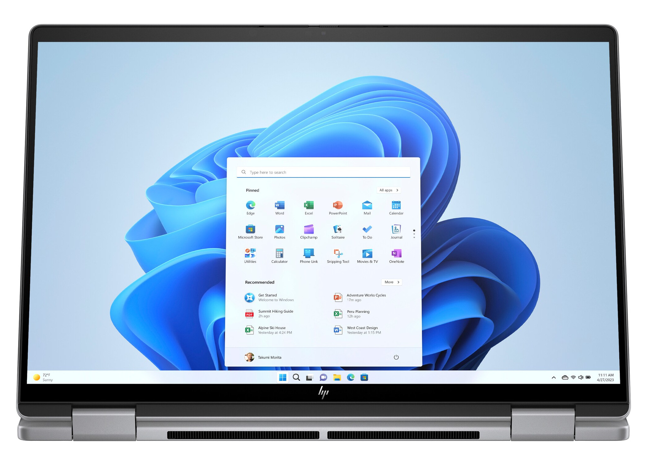 Laptop z wyświetlonym ekranem startowym systemu Windows 11.