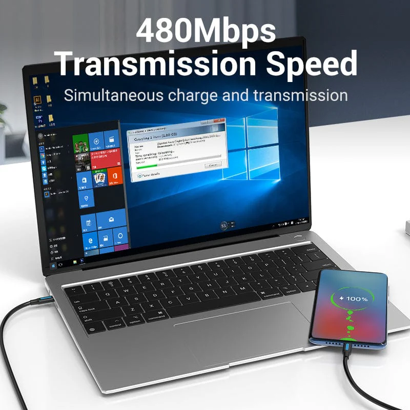 Laptop egy telefont tölt. Szöveg overlay: 480 Mbps átviteli sebesség, egyidejű töltés és átvitel.