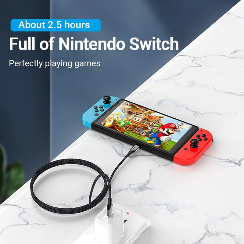 Nintendo Switch játékokkal a képernyőn, töltés egy fehér elosztó közelében.