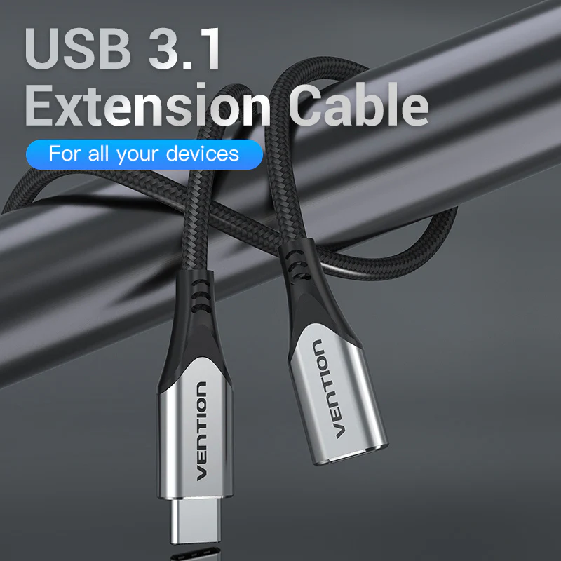 USB 3.1 hosszabbító kábel, fekete kábel ezüst végekkel, fém rúd köré tekerve.