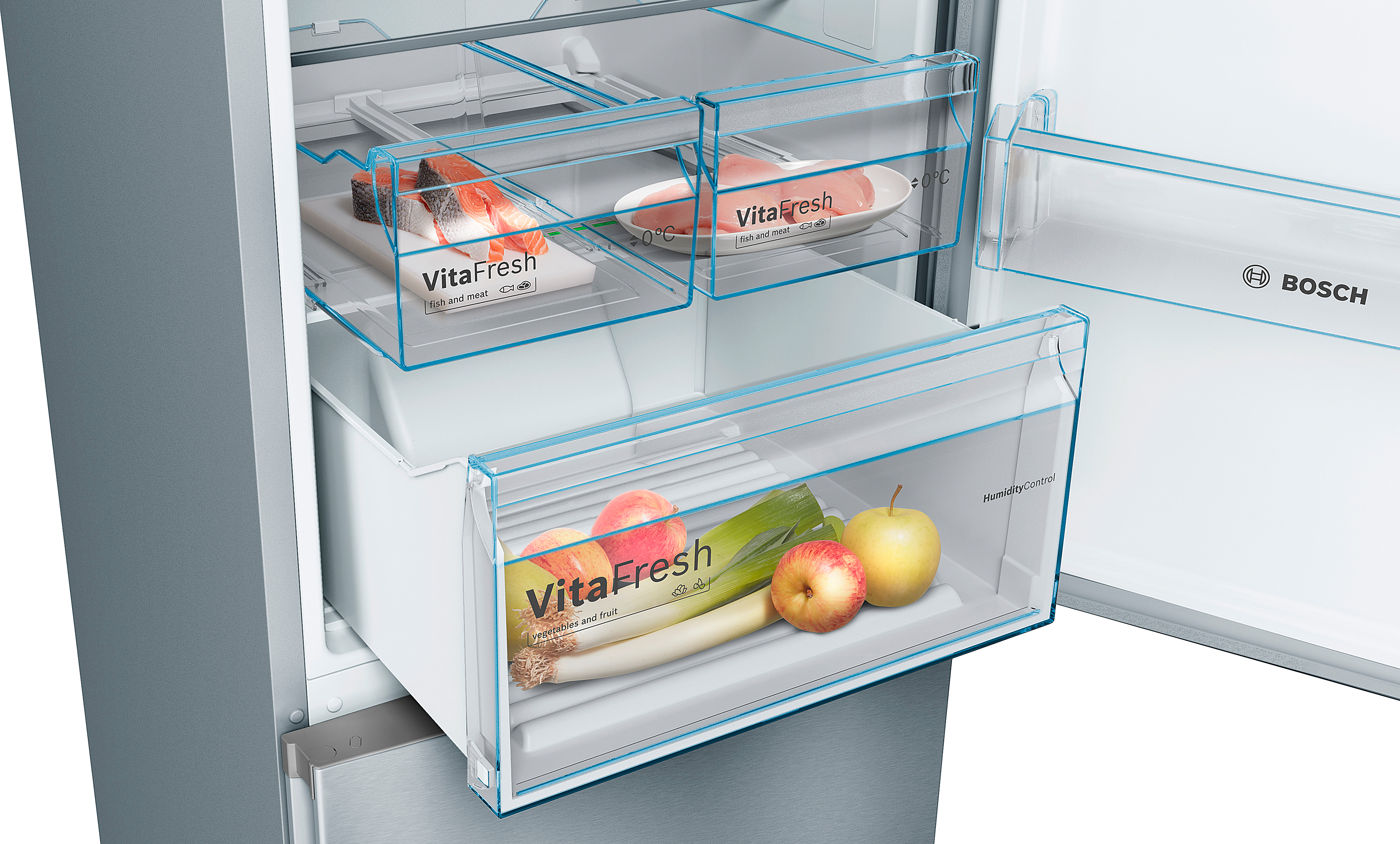 Primer plano de un cajón de refrigerador, con frutas, verduras y alimentos dentro.