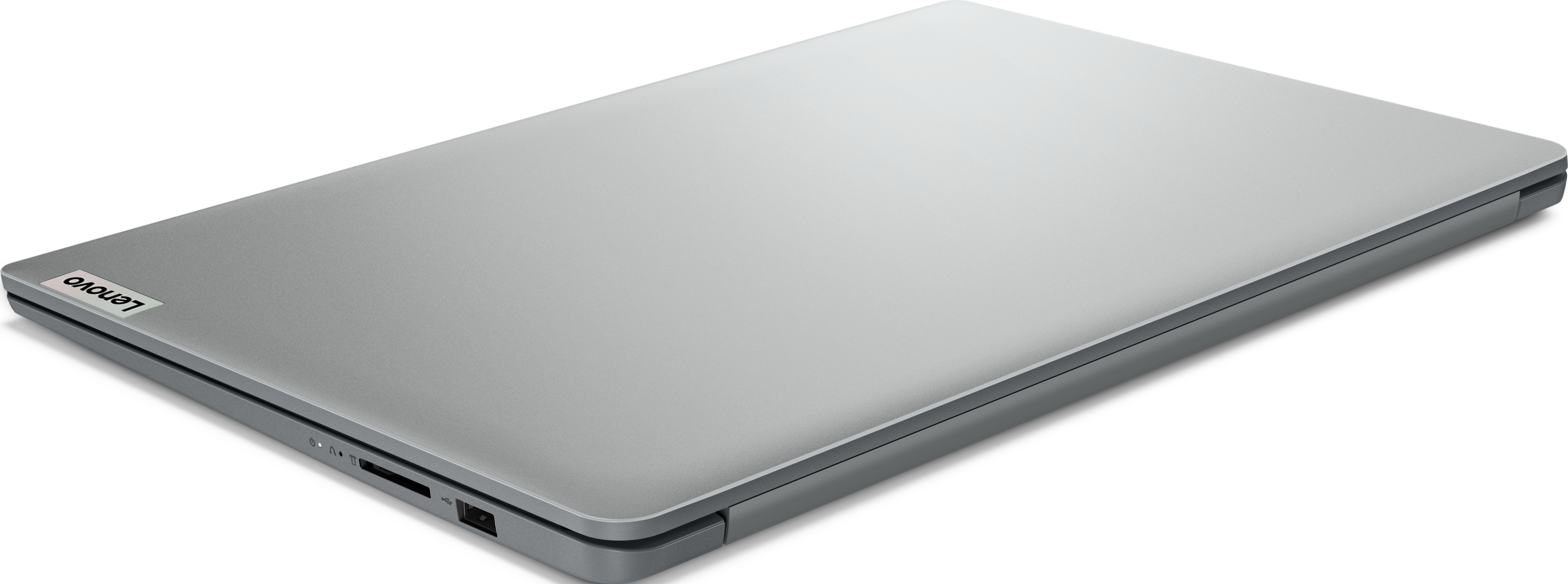 Un ordinateur portable Lenovo argenté fermé sur fond blanc, montrant le côté avec les ports.