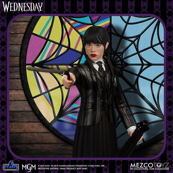 Eine Wednesday Addams Actionfigur, die ein Messer hält, vor einem Buntglasfenster.