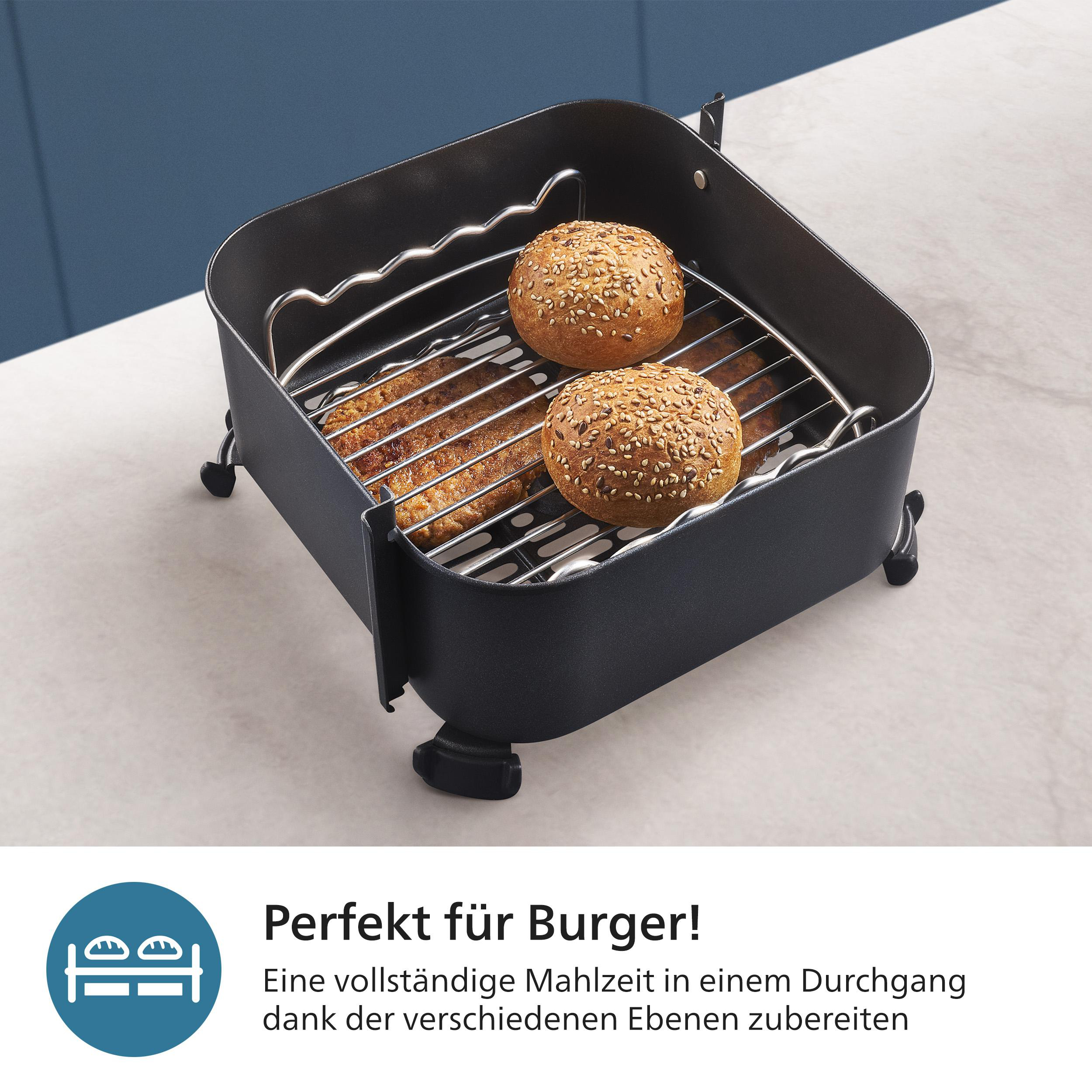 Airfryer-Korb mit zwei Burgerbrötchen und ein paar gekochten Patties. Text sagt, perfekt für Burger.