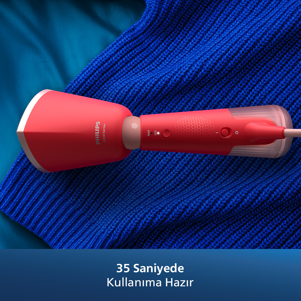 Mavi örgü bir yüzey üzerinde kırmızı bir Philips giysi vapuru. Metin: 35 saniye, kullanıma hazır.