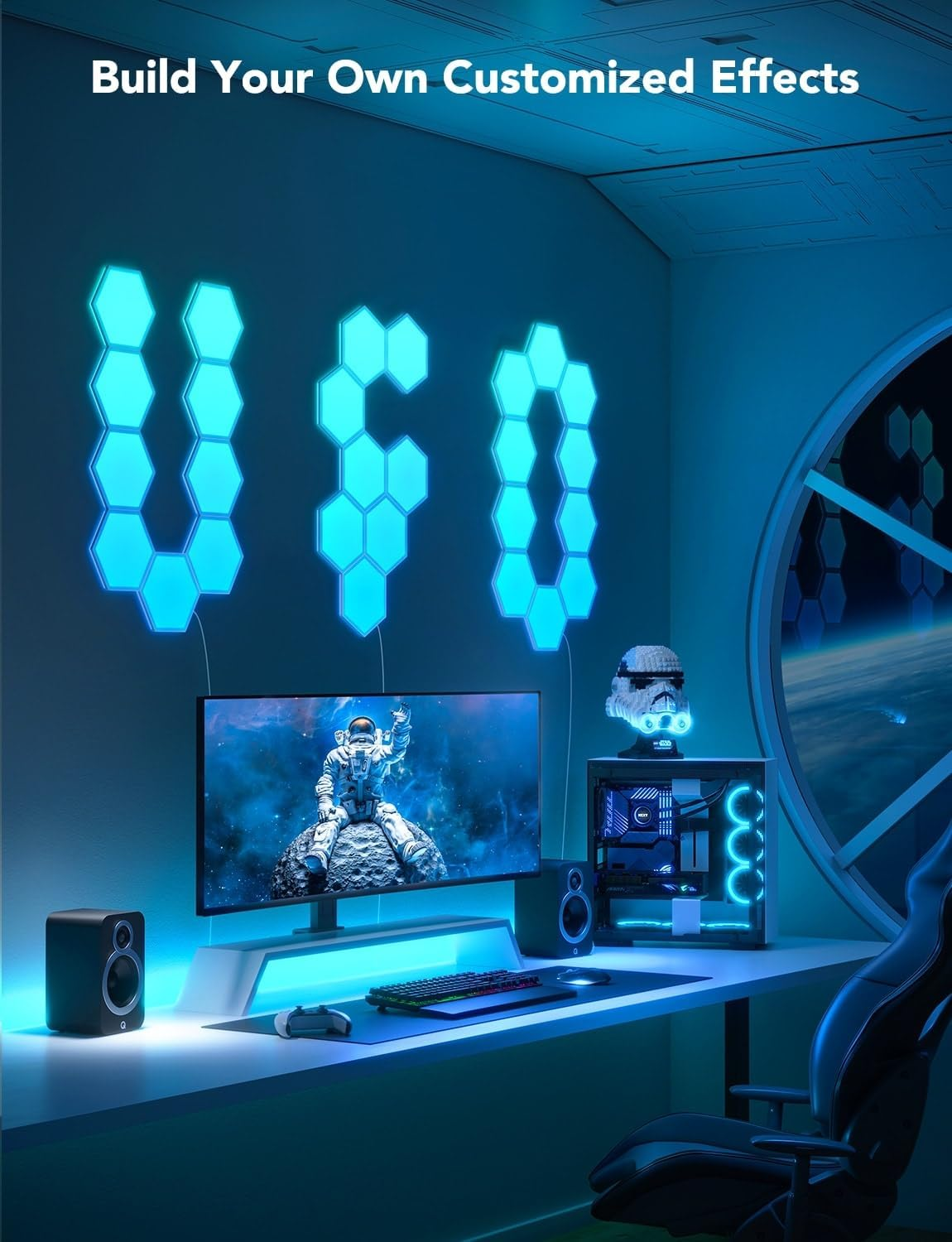Ein Gaming-Setup mit sechseckigen LED-Leuchten mit der Aufschrift 'UFO', einem Monitor und einem Schreibtisch mit PC und Zubehör.