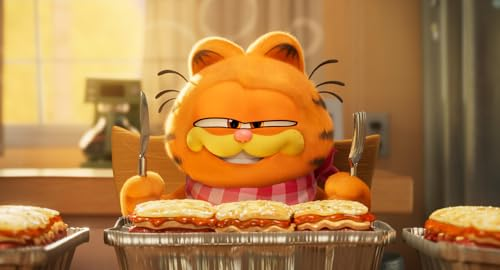 Garfield the cat smiles, holding a fork and knife, near lasagna.