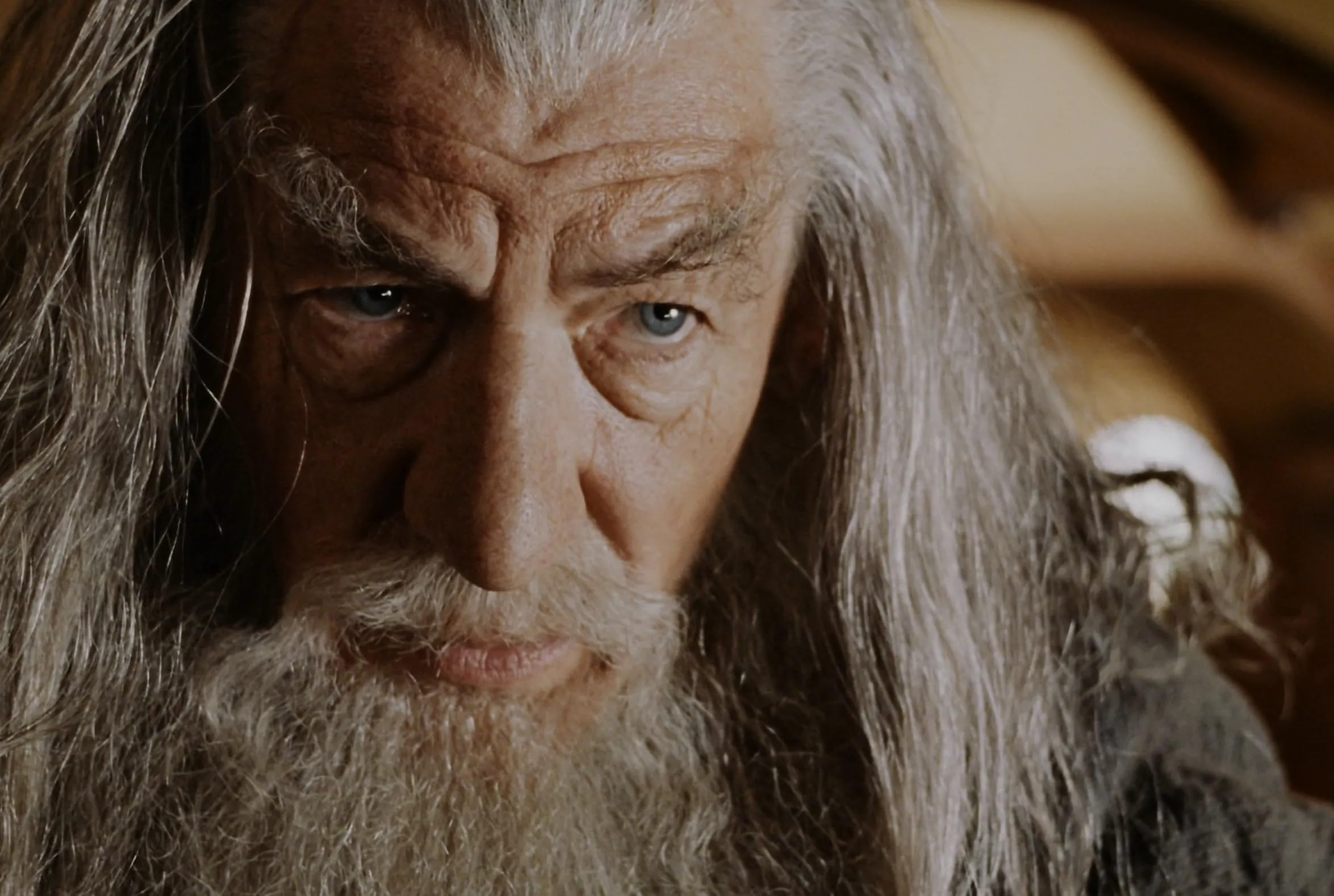 Gandalf du Seigneur des Anneaux, gros plan du visage, barbe blanche, yeux bleus.