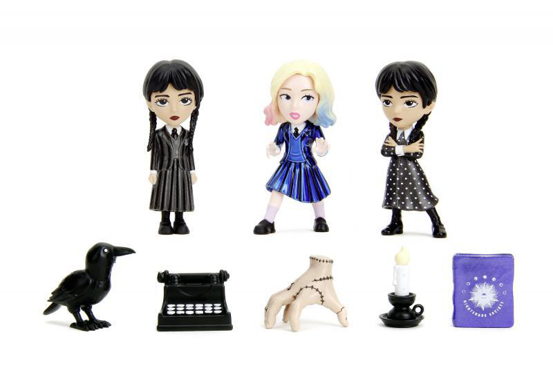 Drei Wednesday Addams-Figuren mit verschiedenen Accessoires. Eine Krähe, eine Schreibmaschine, eine Hand, eine Kerze und ein Buch.