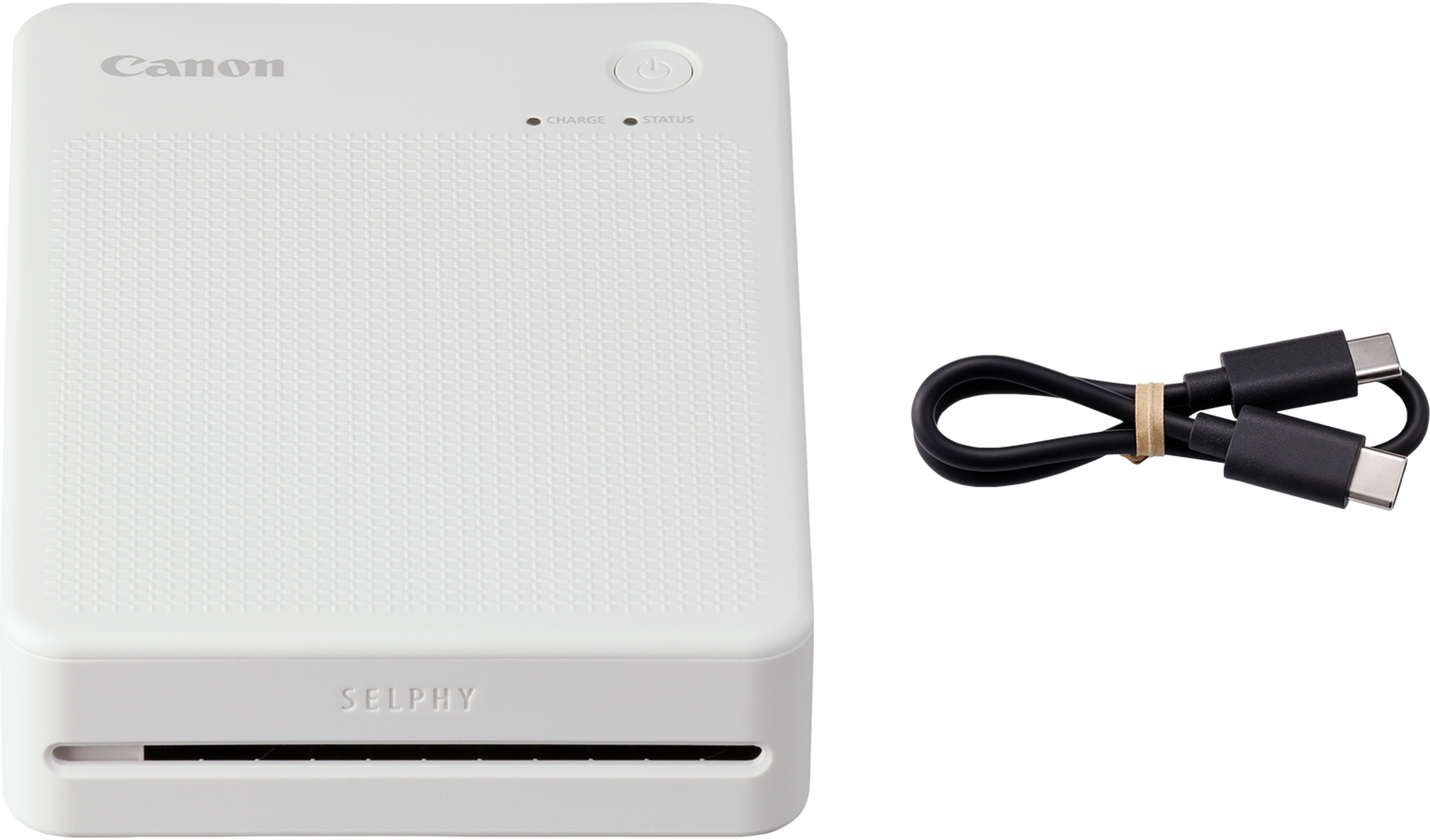 Imprimante photo Canon Selphy blanche, avec câble USB sur fond noir.