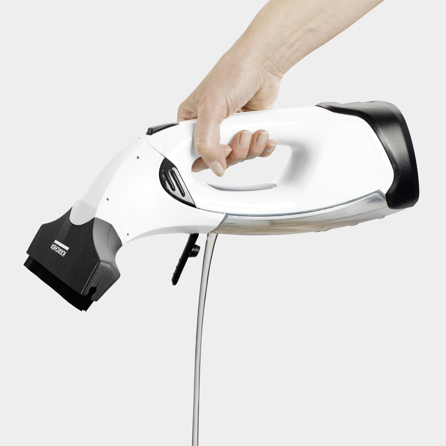 A person holding a white Kärcher window cleaner, showing the cleaning surface.