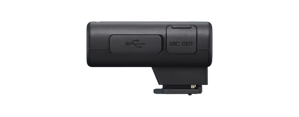 USB portu ve MIC OUT portu olan küçük siyah bir cihaz. Cihaz siyah bir arka plan üzerinde.
