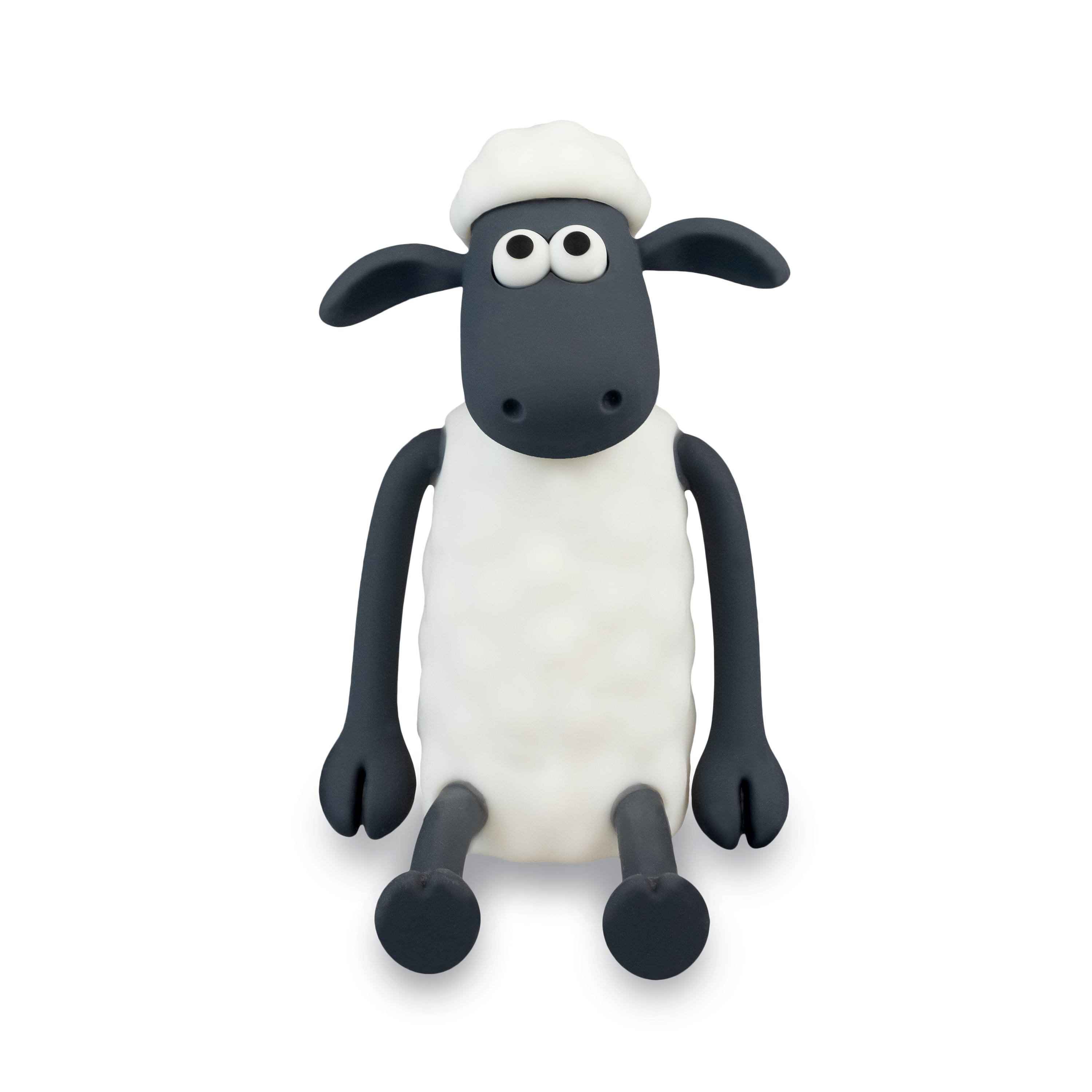 Shaun das Schaf Figur, sitzend, weißer Körper, schwarzes Gesicht und Beine.