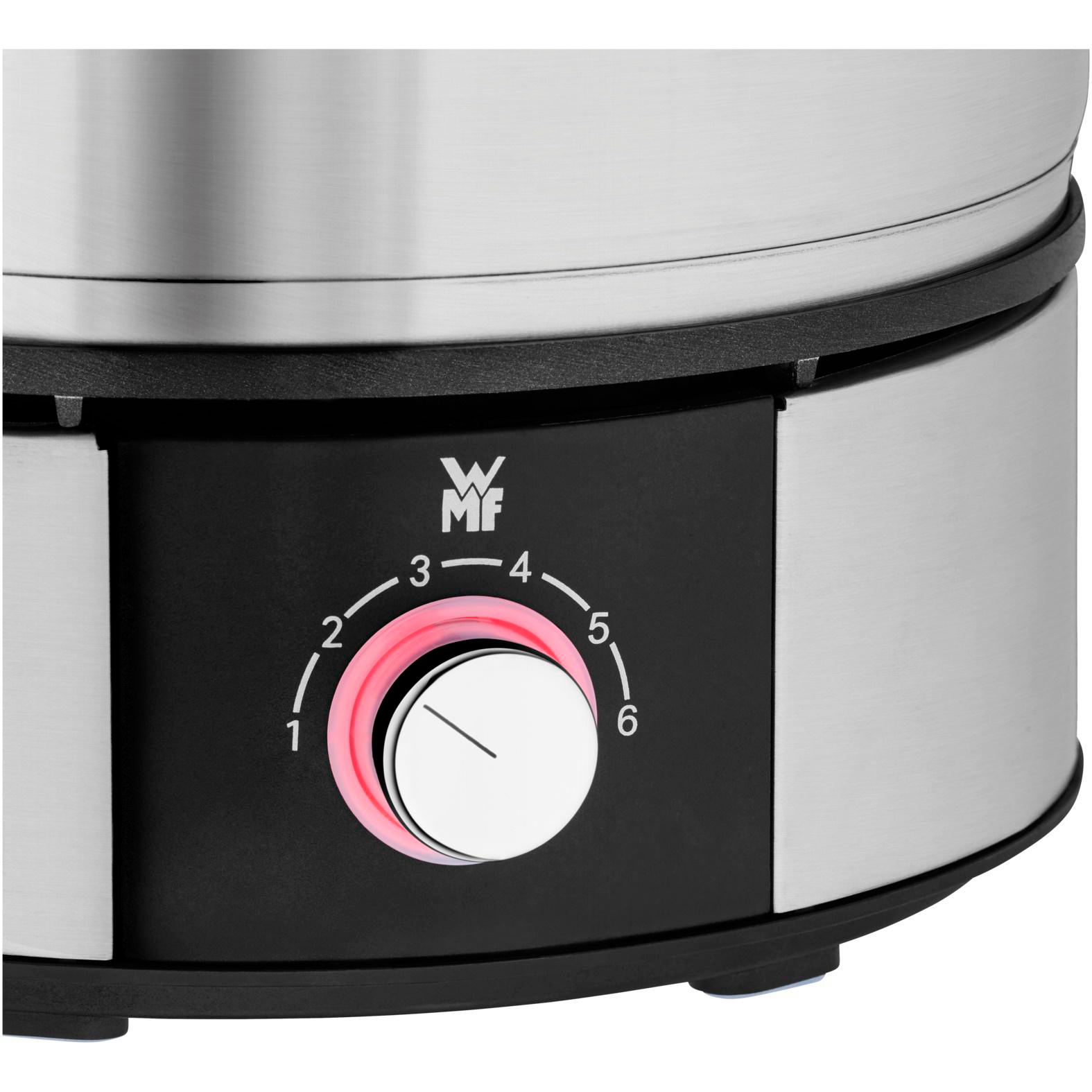 Nahaufnahme des Bedienfelds eines Fondue-Topfes. Ein Drehregler zeigt Zahlen und ein Licht.