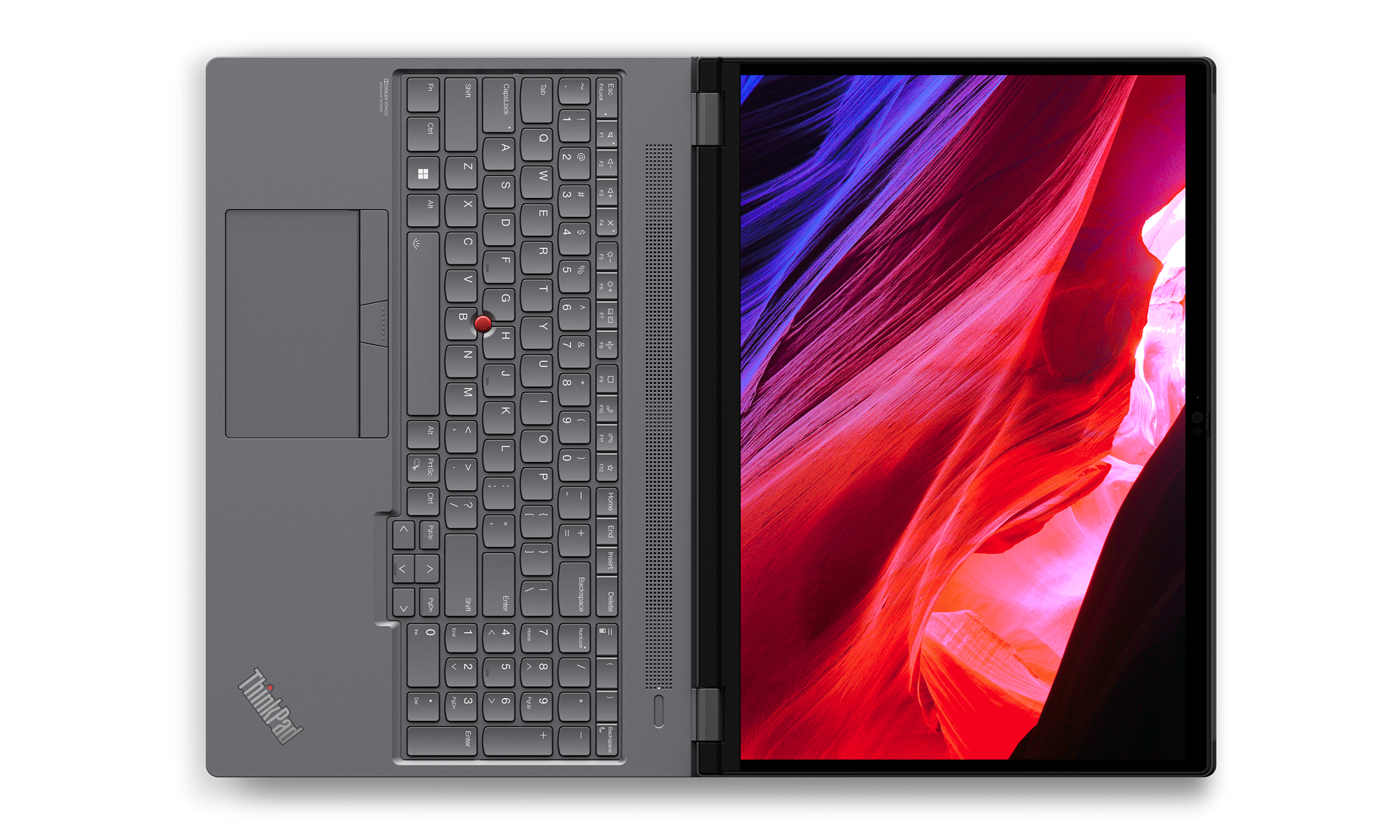 Portátil abierto, teclado y pantalla mostrando un paisaje rojo y azul.