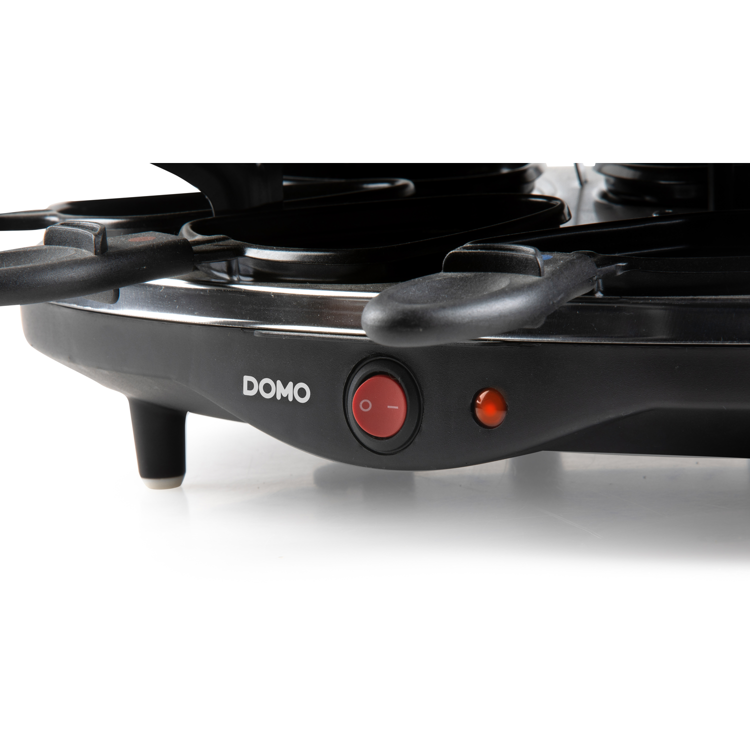 Close up of a black raclette grill. It has a red power button. The brand name DOMO is visible.