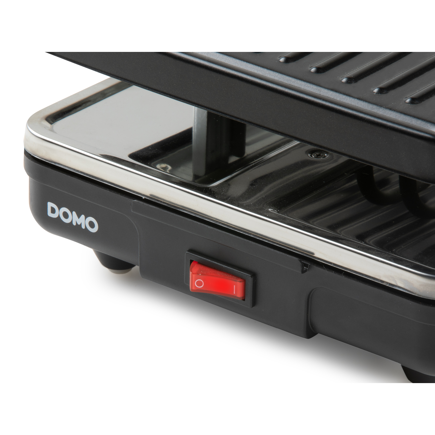 Close up of a raclette grill power button. The brand name DOMO is visible. White background.