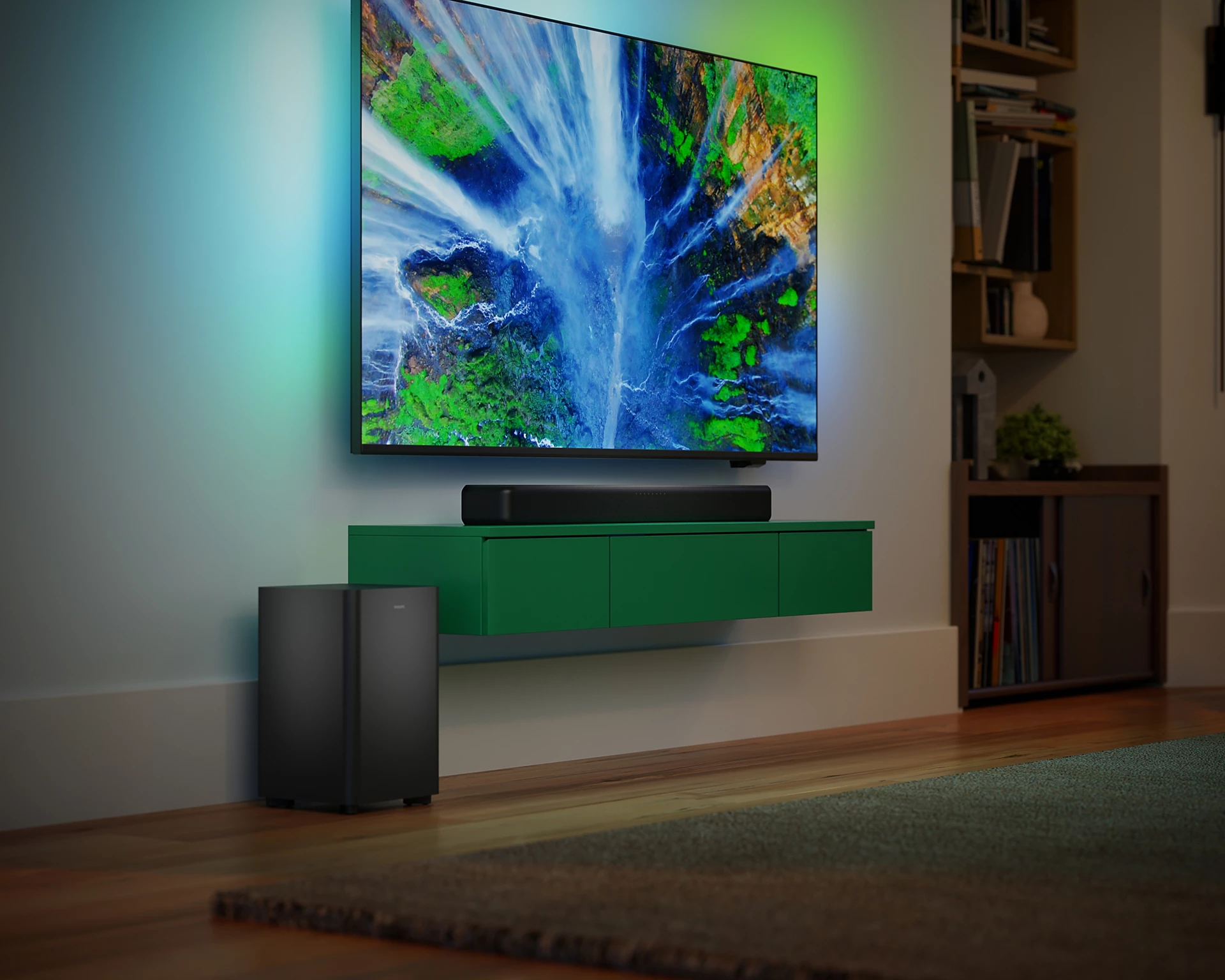 Salón con TV, barra de sonido y subwoofer; mueble verde, con iluminación ambiental.