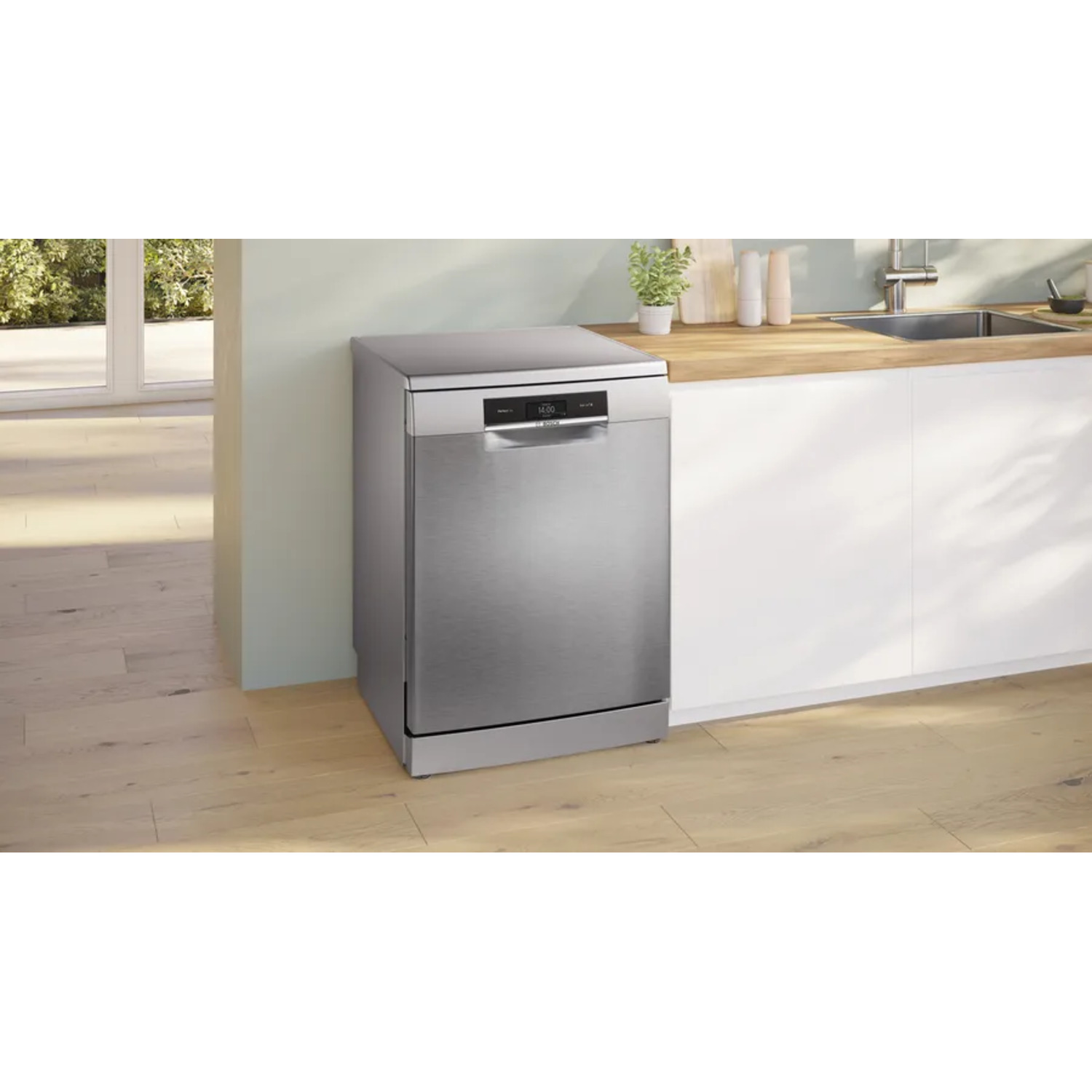 Stainless steel dishwasher in a kitchen setting. Wooden floor, white cabinets, countertop, and sink are visible.