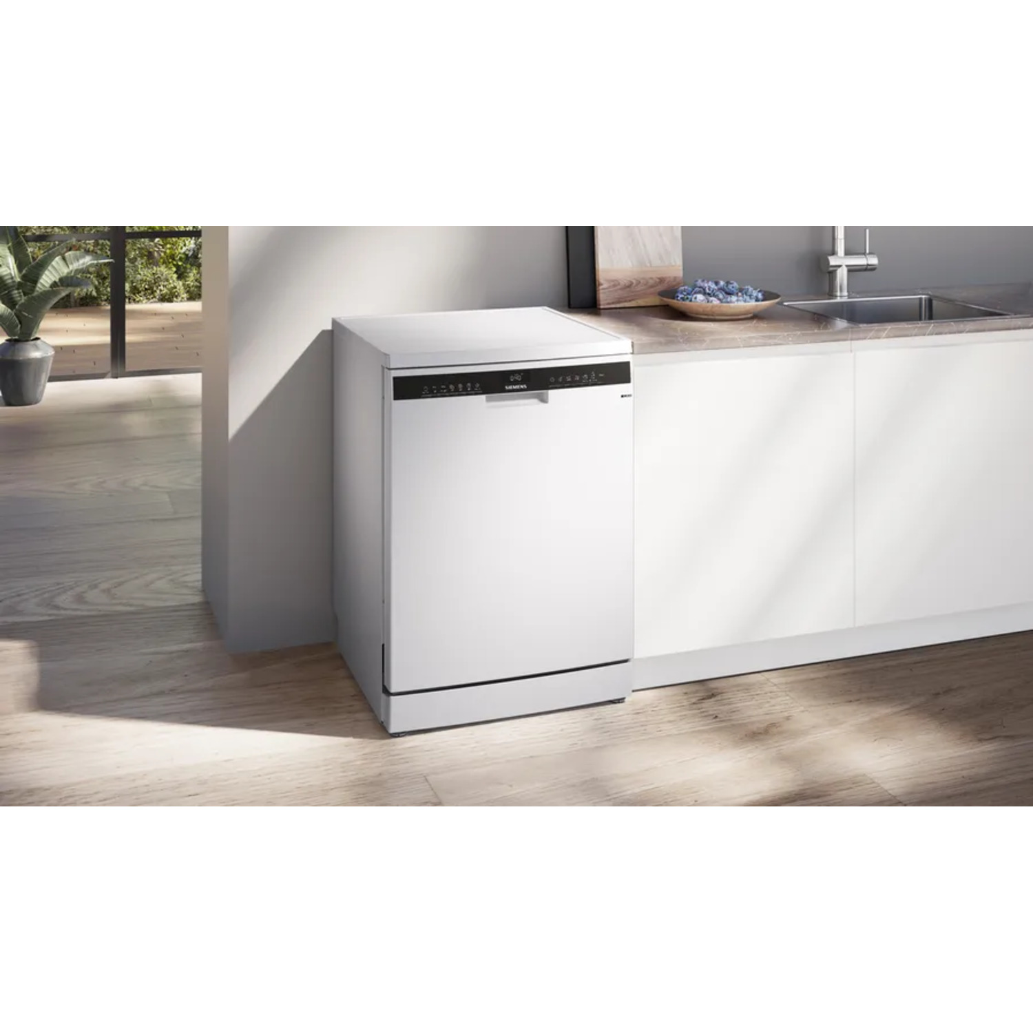 White Siemens dishwasher in a kitchen setting. The floor is wood, and there is a sink nearby.