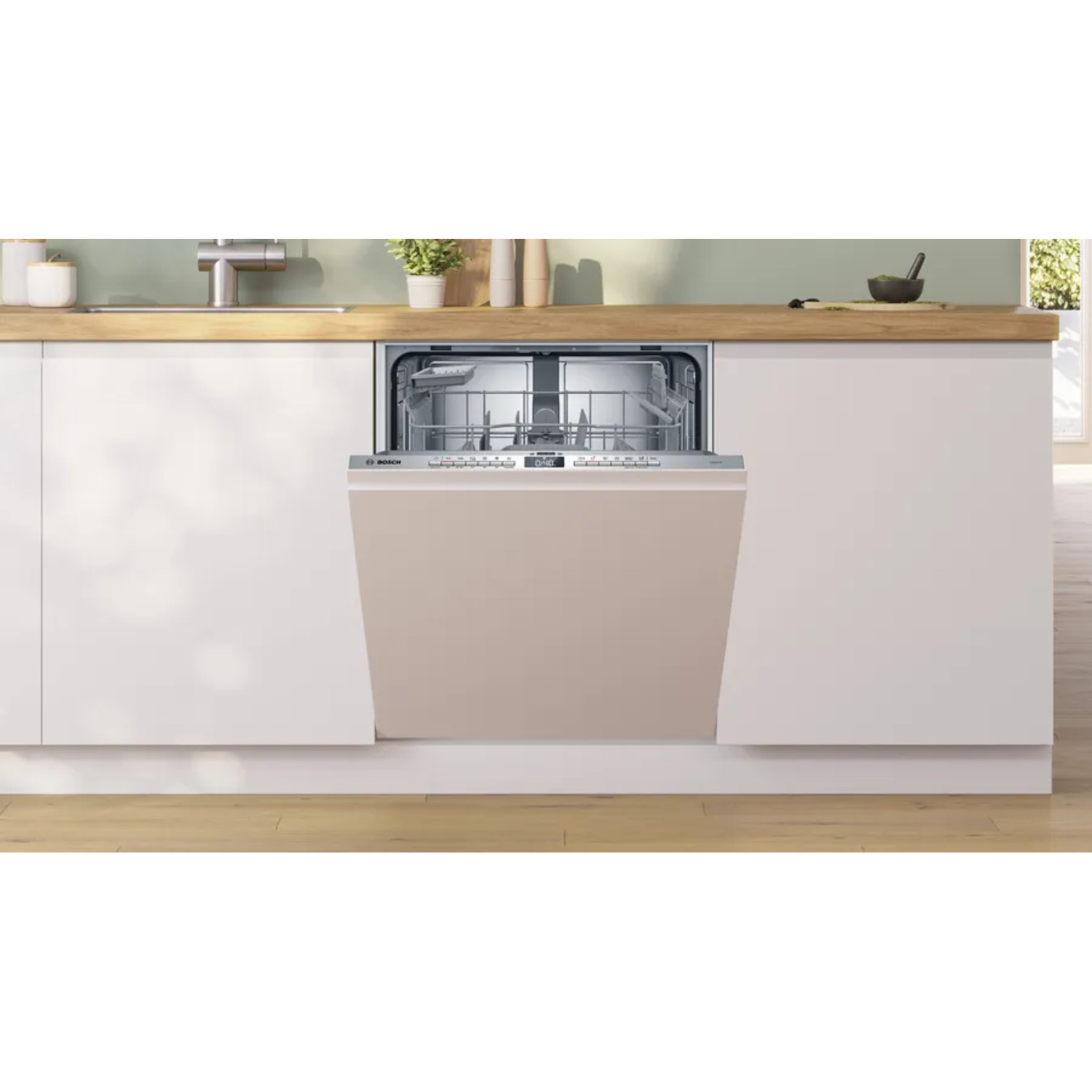 Een vaatwasser met een gesloten beige deur, in een keuken.